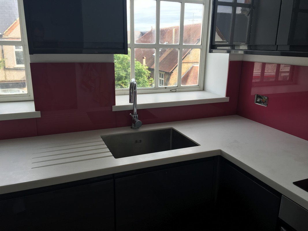 Deep plum coloured glass splashback in modern Merton kitchen